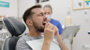 An image of a patient experiencing a dental emergency, such as a severe toothache or injury