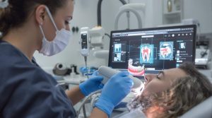 Dentist scanning a patient with an intraoral scanner, showcasing digital dentistry technology
