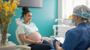Image of a pregnant woman discussing how pregnancy affects oral health