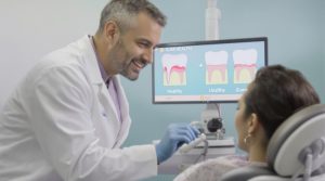 Patient and dentist discussing the link between gum disease and heart health during checkup