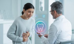 Patient with digestive issues experiencing oral health concerns like tooth decay and dry mouth
